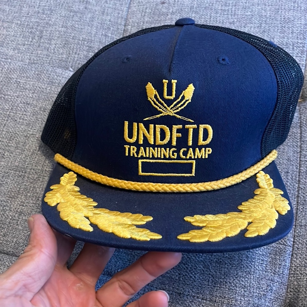 Undefeated training camp snap back hat.